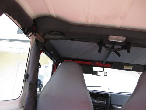 1998 Jeep Wrangler - Interior shot of a Jeep Wrangler, focusing on the headliner and grab handles.