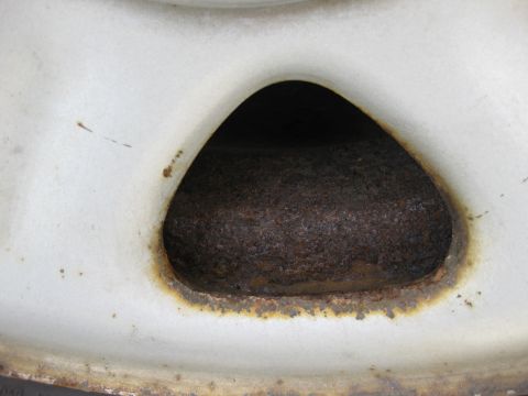 1998 Jeep Wrangler - This image shows a heavily rusted wheel well, indicating significant wear and tear on the vehicle's components.