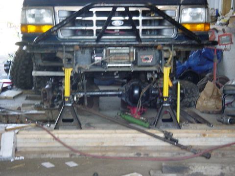 1992 Ford Bronco - Front axle and suspension of a 1992 Ford Bronco are visible while on jack stands.