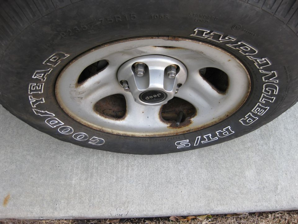 Close-up of a Jeep Wrangler tire with 'Goodyear Wrangler RT/S' text and a Jeep center cap