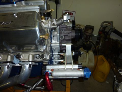 1971 Ford Mustang - Close-up of a V8 engine's chrome valve cover and associated fuel system parts.