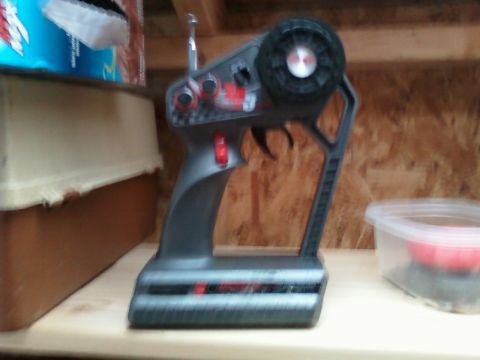 1996 Ford Bronco - A remote control transmitter sits on a shelf, with other items blurred in the background.