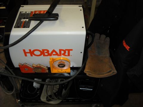 1979 Ford F-150 - A Hobart welding machine is shown with protective gloves and magnetic clamps nearby.