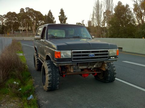 1989 Ford Bronco - This 1989 Ford Bronco features a lifted suspension and oversized tires for off-road capability.
