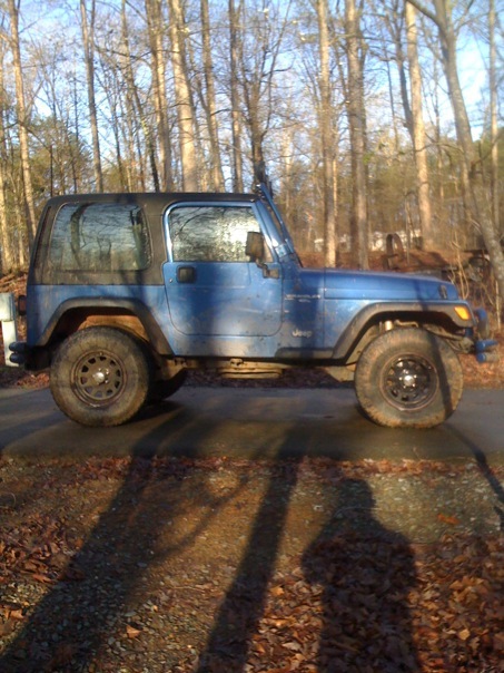1998 Jeep Wrangler - Side view of a blue Jeep Wrangler with a hardtop, parked outdoors.