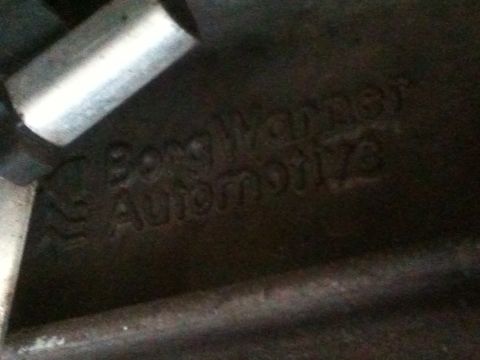 1995 Ford Bronco - Close-up of a cast metal part showing embossed text from Borg Warner Automotive.