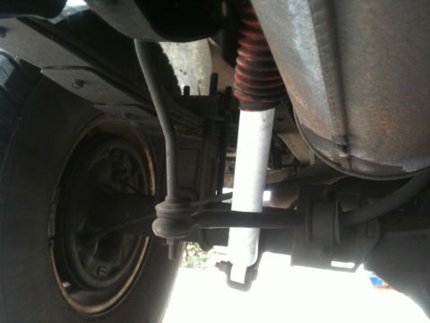 1995 Ford Bronco - The photo shows the rear suspension components of a vehicle, including a shock absorber and leaf springs.
