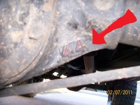 1970 Ford Bronco - A close-up view of a vehicle's undercarriage shows markings on the frame.