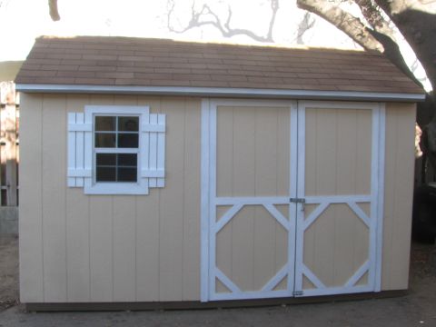 1968 Ford Mustang - A tan shed with white trim and double doors is shown from the front.