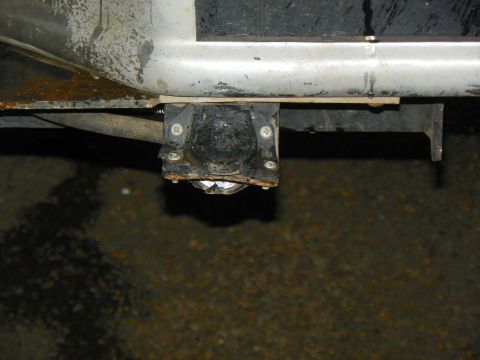 1994 Ford Bronco - Close-up of a trailer hitch wiring connector, showing signs of rust and age.