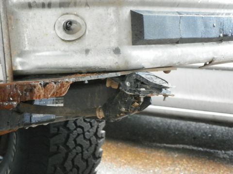 1994 Ford Bronco - Close-up of a trailer hitch assembly, showing rust and damage to the plastic components.