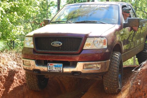 2005 Ford F-150 - This 2005 Ford F-150 navigates a challenging off-road terrain with its front end angled towards the viewer.