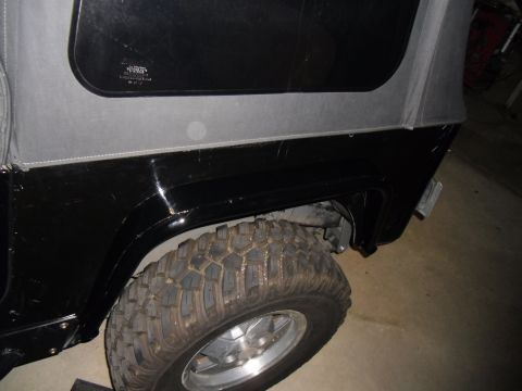 1992 Jeep Wrangler - Close-up of the rear fender and tire on a 1992 Jeep Wrangler with a soft top.