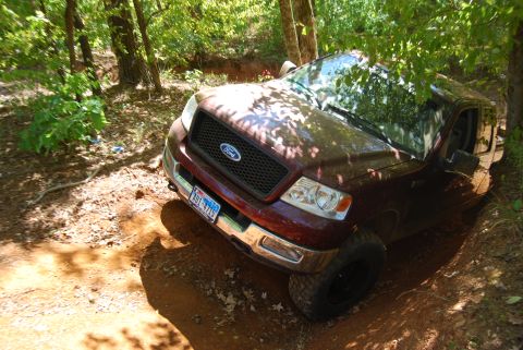 2005 Ford F-150 - Ford F-150 navigating a wooded off-road trail.