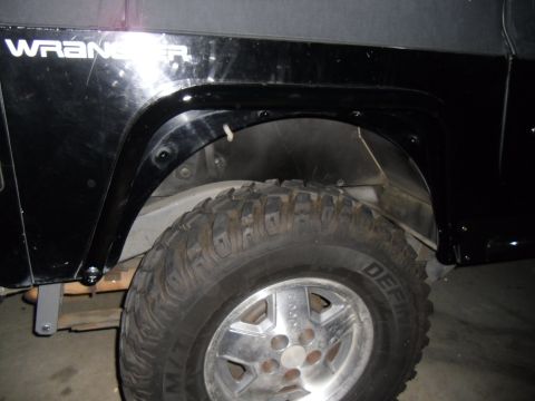 1992 Jeep Wrangler - Detail shot of the rear fender and wheel well of a Jeep Wrangler.