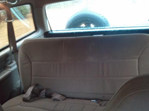 1993 Ford Bronco - The rear seat and spare tire are visible from inside the vehicle.