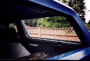 1985 Ford Bronco - View from inside a 1985 Ford Bronco, showing the rear interior and the exterior scenery.