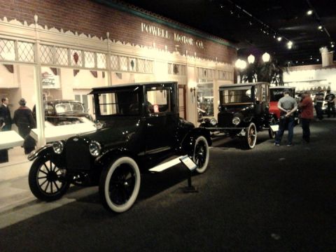 1995 Ford Taurus - Vintage cars are displayed at the Powell Motor Co. exhibit within a museum setting.