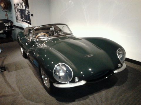 1995 Ford Taurus - A classic Jaguar XKSS is displayed in a museum setting, with another vehicle visible in the background.
