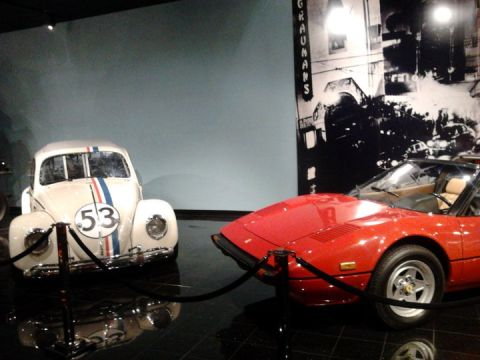 1995 Ford Taurus - Herbie the Love Bug and a red convertible sports car are displayed at the Peterson Automotive Museum.