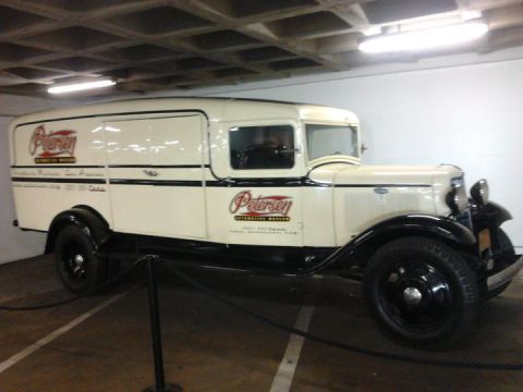 1995 Ford Taurus - Panel van with Petersen Automotive Museum livery displayed indoors.