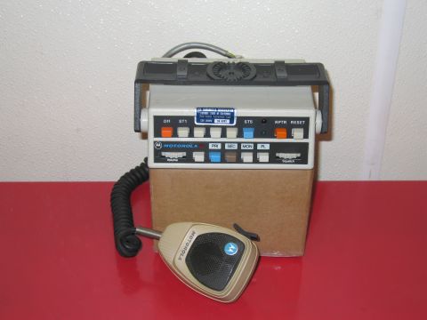 2001 Ford Crown Victoria - Motorola radio transceiver with microphone, labeled with various buttons and controls.