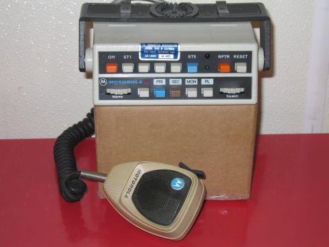 2001 Ford Crown Victoria - A Motorola radio unit with a separate microphone sits on a cardboard box.