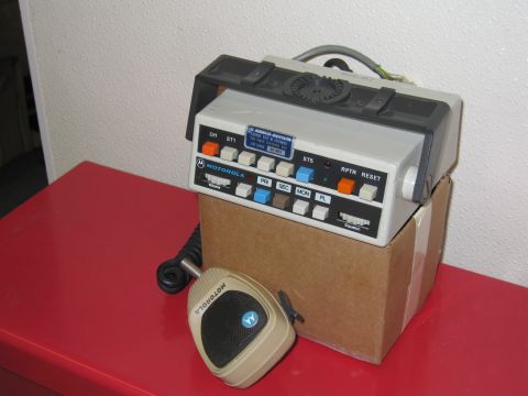 2001 Ford Crown Victoria - Motorola radio transceiver and microphone on a red surface.