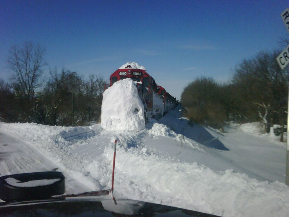 Train front buried in snowdrift, with numbers 4003 visible
