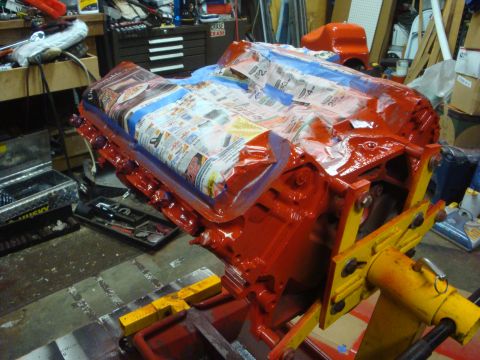 1989 Ford Bronco - Engine block is covered with newspaper and tape, suggesting it is being prepped for painting or further work.