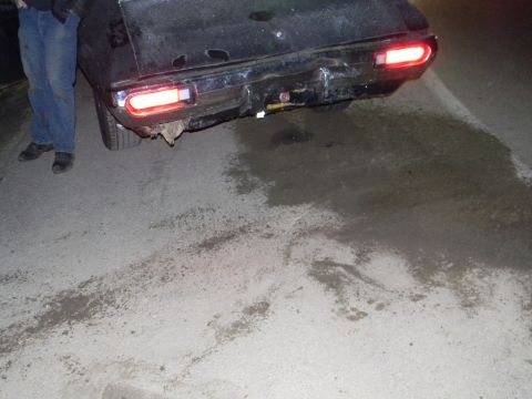 1975 Ford Ranchero - Rear view of a black 1975 Ford Ranchero with significant rear-end damage.
