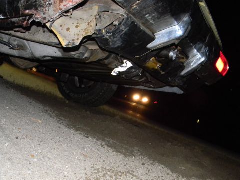 1975 Ford Ranchero - Underside view of a damaged vehicle, revealing a tire and rear bumper. The registry information suggests it is a 1975 Ford Ranchero, but vi…