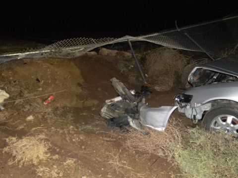 1975 Ford Ranchero - A silver car sustained significant front-end damage after an apparent accident, with debris strewn across the scene.