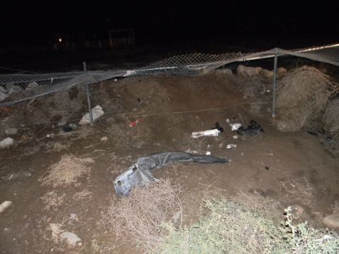 1975 Ford Ranchero - Debris from a vehicle crash lies scattered on the ground at night.