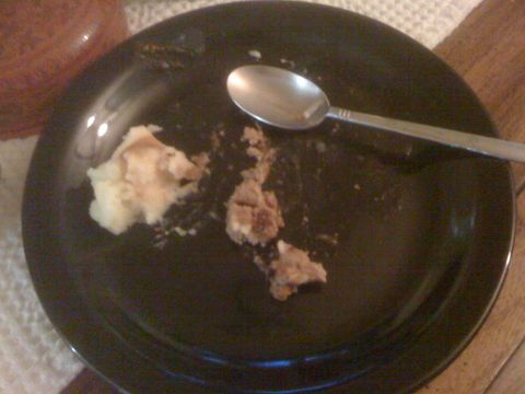 1968 Ford Mustang - Plate with leftover food and a spoon after a meal.