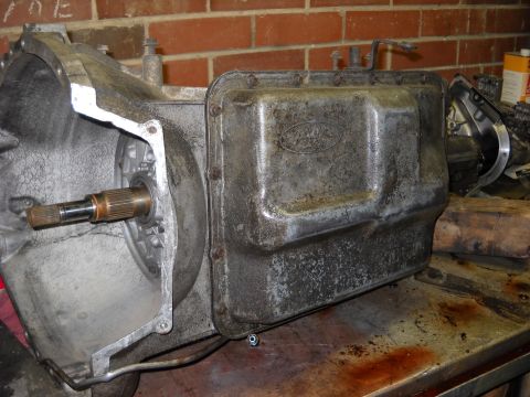 1993 Ford C-150 (Centurion Conversions) - Close-up of a Ford E4OD transmission pan, showing the Ford oval logo.