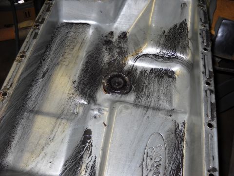 1993 Ford C-150 (Centurion Conversions) - This transmission oil pan shows significant buildup and wear, indicating a need for service or replacement.