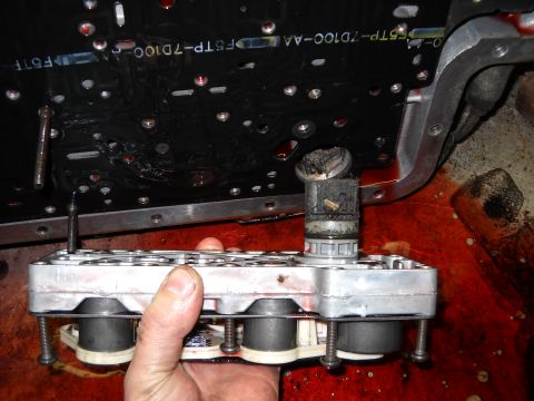 1993 Ford C-150 (Centurion Conversions) - A transmission valve body and circuit board are shown, with spilled transmission fluid visible.