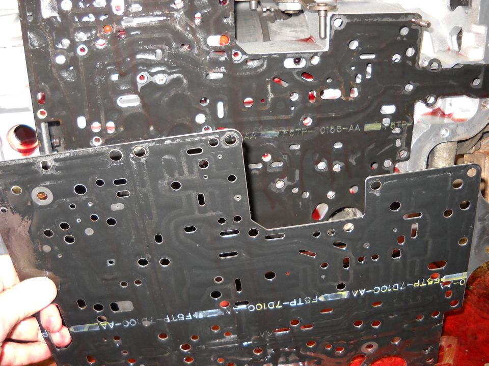 Transmission valve body with part numbers F5TP-7D100-AA and F6TF-C186-AA
