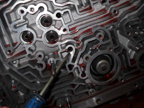 1993 Ford C-150 (Centurion Conversions) - Close-up of an automatic transmission valve body, showing intricate channels and fluid.