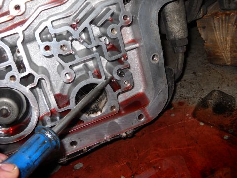 1993 Ford C-150 (Centurion Conversions) - Automatic transmission valve body during a rebuild, showing internal components and fluid.
