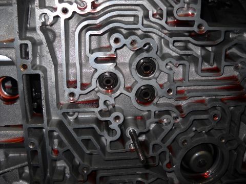 1993 Ford C-150 (Centurion Conversions) - Detailed view of a complex automatic transmission valve body, showing intricate channels and fluid pathways.