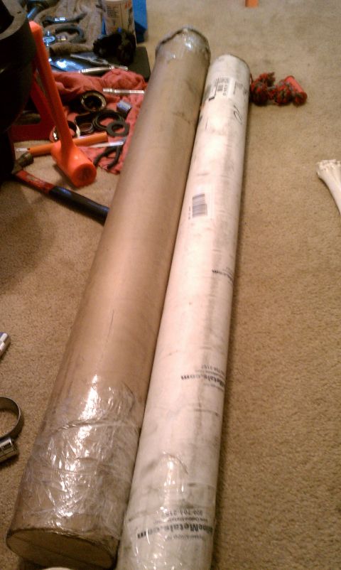 1990 Ford Bronco - Rolled materials and tools are on the floor. The white roll has text and a barcode visible.