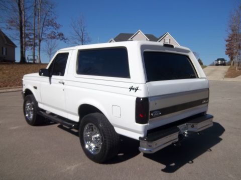 1995 Ford Bronco - Rear view of a white 1995 Ford Bronco SUV parked outdoors on a sunny day.