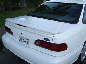 1993 Ford Taurus - Rear view of a white 1993 Ford Taurus sedan, a spoiler and California license plate.