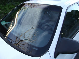 1993 Ford Taurus - Close-up of a car's windshield and side mirror, showing reflections.