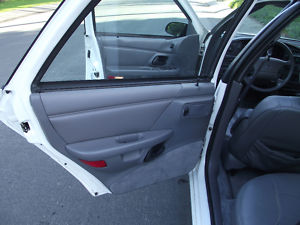 1993 Ford Taurus - View of the interior of a 1993 Ford Taurus, focusing on the passenger side door and dashboard.