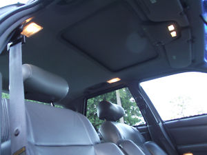1993 Ford Taurus - The interior of a car is shown, a sunroof and gray leather seats.