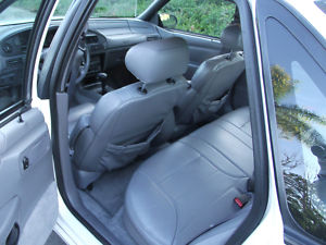 1993 Ford Taurus - View of the interior of a white sedan, highlighting the seating and dashboard area.
