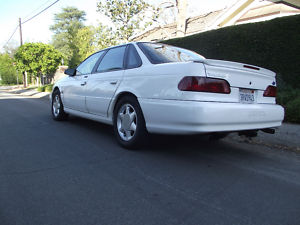 1993 Ford Taurus - Rear view of a white 1993 Ford Taurus sedan parked on a street.